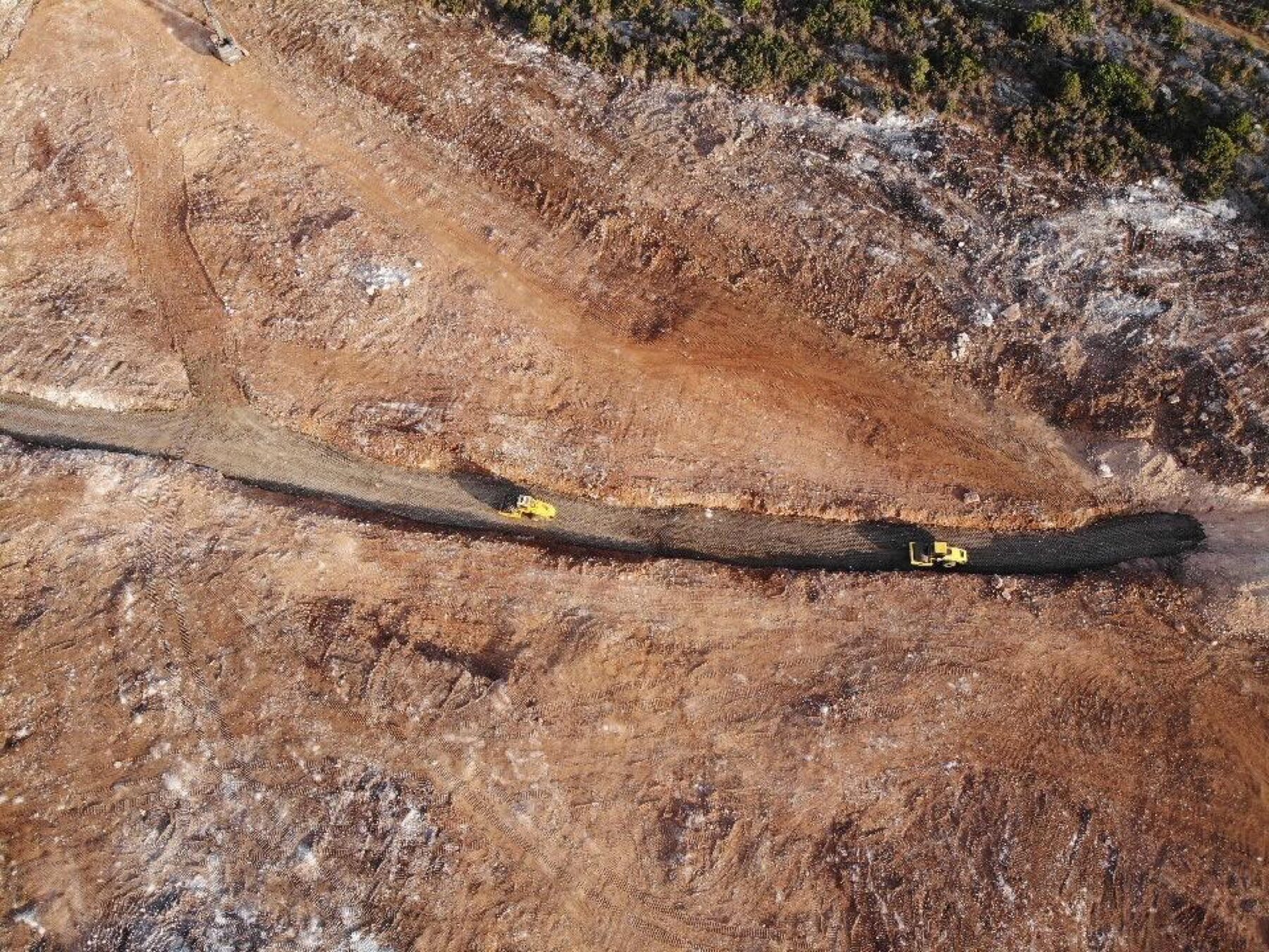 Excavator on graded road