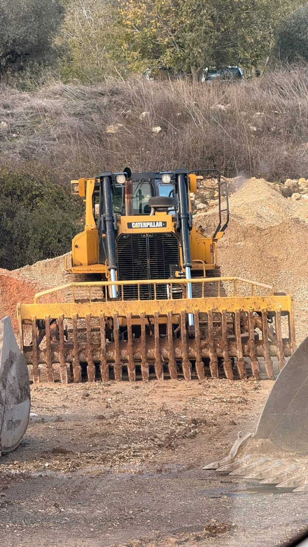 CAT dozer fitted with a rock rake