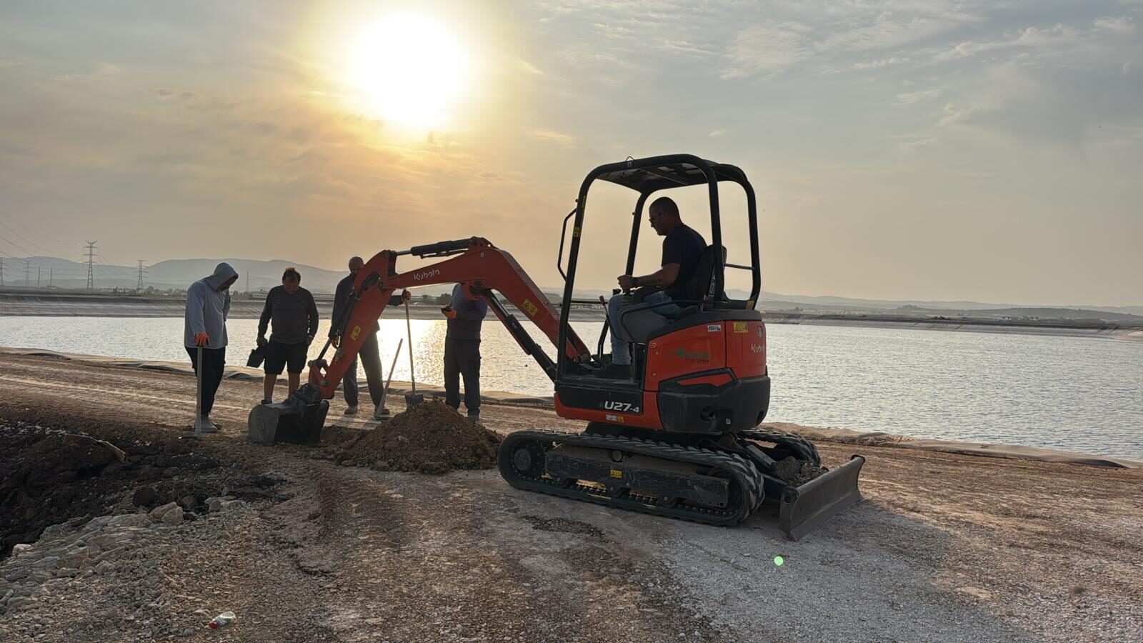 Kubota U27-4 mini excavator with crew at a reservoir